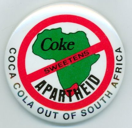 The round button features a green map of the continent of Africa, with South Africa in red. A red stop sign contains the word &quot;sweetens&quot; in the phrase &quot;Coke sweetens Apartheid.&quot; The button was created by the Atlanta office of the American Friends Service Committee (AFSC), which coordinated the Coke Boycott Campaign. The button was produced by Donnelly/Colt Buttons in Hampton, Connecticut.